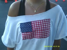 a woman wearing a white shirt with an american flag on it