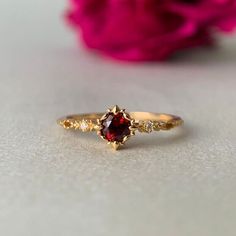 a close up of a ring with a flower in the background