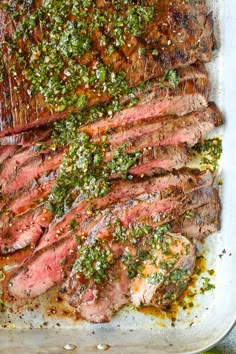 sliced steak with herbs and seasoning on top