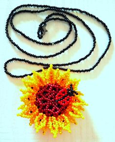 This authentic necklace is the perfect option to add colour, style and beauty to any outfit. This Sunflower necklace is completely handmade. Yellow Flower Necklaces For Jewelry Making, Bohemian Sunflower Design Jewelry With Round Beads, Yellow Flower Necklace With Colorful Beads As Gift, Handmade Orange Flower-shaped Jewelry, Handmade Orange Beaded Necklaces As Gift, Handmade Orange Beaded Pendant Necklace, Yellow Beaded Flower Necklace As Gift, Yellow Beaded Flower Necklace Gift, Yellow Beaded Flower Necklace For Gift