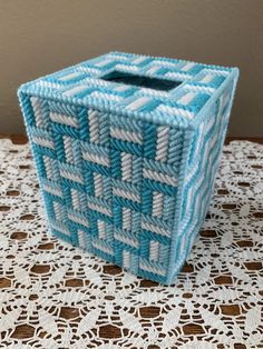 a blue and white basket sitting on top of a table