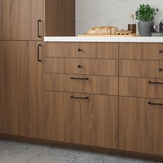 a kitchen with wooden cabinets and white counter tops