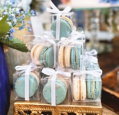 there are many macaroons in the box on the table and one is blue