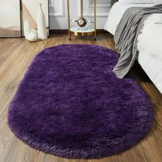 a large purple rug on the floor in a bedroom