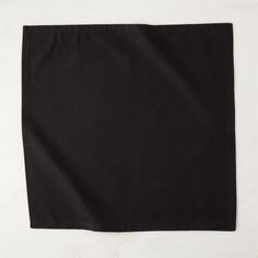 a black napkin sitting on top of a white table