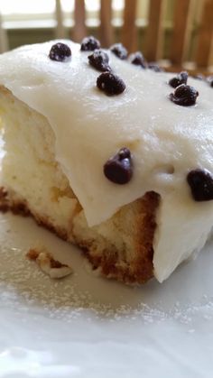 a close up of a piece of cake on a plate with chocolate chip toppings