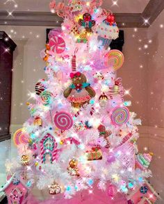 a pink christmas tree decorated with lollipops and candy