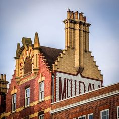 an old brick building with a large sign on it's side that says metala