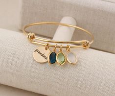 "Grandma bracelet with birthstones Personalized Grandmother Grandma Jewelry Grandmother Gift ◆ SIZE - BANGLE SIZE : Diameter is 65mm across. ( Adjustable Bangle ) - COIN CHARM SIZE : 15mm - BIRTHSTONE SIZE: 9mm x 13mm( .35\" x .5\" ) ◆ Material - Gold / Rose gold / White gold Plating over Brass finding ** BIRTHSTONE ** 1. January - Garnet 2. February - Amethyst 3. March - Aquamarine 4. April - Crystal 5. May - Emerald 6. June - Moonstone 7. July - Ruby 8. August - Peridot 9. September - Sapphire Mother's Day Personalized Stackable Jewelry, Adjustable Jewelry For Mom's May Birthstone Gift, Mother's Day Gift Bangle Jewelry, Mother's Day Gift Bangle Jewelry For Mom, Mother's Day Bangle Gift For Mom, Mother's Day Name Bracelet With Birthstone, Mother's Day Birthstone Name Bracelet, Adjustable Jewelry As Personalized May Birthstone Gift, Adjustable Birthstone Bracelets As Gift For Mom