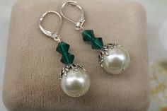 Emerald Green and White Pearl Earrings- Silver Leaf Earrings- Couquette Earrings- Vintage Style 1920's 1930's Earrings- Pearl Drop Earrings  Crystal white pearls that are 12mm  Sitting on top is a silver plated leaf bead cap with three Swarovski emerald green crystals.  They suspend from silver plated lever back ear wires.  1 5/8 inches long They arrive gift boxed with a bow Thanks for looking, Lori Classic Handmade Earrings For Party, Elegant Green Nickel-free Clip-on Earrings, Elegant Nickel-free Clip-on Earrings For Evening, Classic Handmade Pearl Earrings For Formal Occasions, Vintage Nickel-free Pearl Earrings For Wedding, Vintage Dangle Pearl Earrings For Anniversary, Elegant Nickel-free Clip-on Earrings For Wedding, Vintage Dangle Pearl Earrings With Ear Wire, Vintage Round Bridal Earrings For Gifts