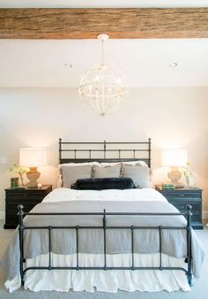 a bedroom with a bed, nightstands and two lamps