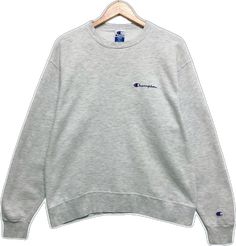 Classic Sweater With Embroidered Logo In Relaxed Fit, Classic Sweater With Embroidered Logo And Relaxed Fit, Classic Relaxed Fit Sweater With Embroidered Logo, Classic Gray Crew Neck Sweatshirt, Classic Crew Neck Tops With Embroidered Logo, Classic Crew Tops With Embroidered Logo, Classic Crew Top With Embroidered Logo, Classic Winter Top With Embroidered Logo, Winter Basic Sweatshirt With Embroidered Logo