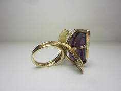 "This completely unique and one of a kind ring was purchased from the estate of a jewelry designer who made many custom and unique pieces in our local area around Cleveland, Ohio in the 70's and 80's. The 14k gold setting features a split ring shank and gold leaves that circle around and beneath the gigantic gemstone. The gemstone is a violet-blue to purple color-change sapphire in a free form cut. Gemstone Dimensions - 27mm x 18mm x 9.5mm Ring Size 5.5. (Can easily be resized to most sizes) Mar Unique Yellow Gold Collectible Jewelry, Unique 14k Gold Rings With Polished Finish, Unique Formal Rings With Polished Finish, Unique 14k Gold Hallmarked Rings, Yellow Gold Rings With Polished Finish, Unique Yellow Gold Rings With Polished Finish, Modernist Hallmarked 14k Gold Jewelry, Handmade 14k Gold Rings, Unique Handmade 14k Gold Rings