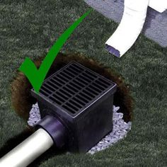 a drain in the ground with a green arrow pointing to it's right side