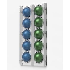 three rows of blue and green balls in a white case on a white background with clippings