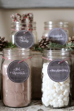 mason jars filled with marshmallows and pine cones