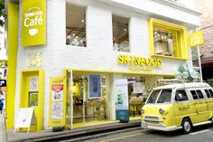 a yellow van parked in front of a store