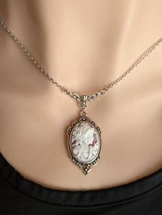 "This beautiful vintage-style Cameo necklace features a classic portrait cameo of a Greek Goddess on a wine coloured background with white relief. Set in an ornate antique silver pendant suspended from a beautiful vintage style floral necklace connector featuring vines and a Tulip. A quintessential gift for anyone that loves vintage-inspired Victorian and Gothic jewelry.  Want to make it an earring and necklace set? You can! Choose your preference in the drop-down menu! NEW! Choose your favourit Old Style Necklace, Cameo Jewelry Necklaces, Antique Jewelry Victorian Vintage Jewellery Pendant Necklace, Vintage Victorian Jewelry, Vintage Cameo Necklace, Vintage Looking Jewelry, Victorian Necklace Aesthetic, Victorian Cameo Necklace, Old Pendant Necklace