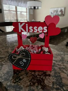 a valentine's day treat box with hearts and kisses in it on a table