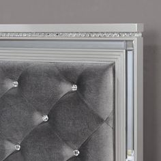 a close up of a silver frame with diamond buttons on the headboard and foot board