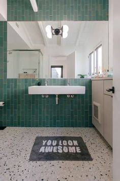 a pretty bright bathroom with turquoise skinny tiles and grey and white terrazzo flooring, white appliances and a large mirror Terrazzo Floor Bathroom, Terrazzo Floor Design, Bathroom Utility, Modern Bathroom Renovations, Porcelain Tile Bathroom, Mid Century Modern Bathroom