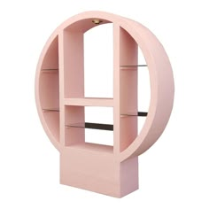 a pink shelf with shelves in the shape of a circle and an opening to it