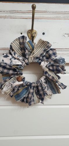 a wreath made out of old jeans hanging on a doorknob with a hook