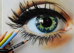 someone is drawing an eye with colored pencils