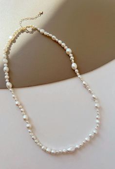 Indulge in the classic beauty of our Freshwater Pearl Necklace. Featuring pearls that boast a radiant glow and impeccable quality, this necklace is the epitome of elegance. Its versatile design makes it suitable for any occasion, from casual gatherings to formal events. Meticulously crafted, this piece promises to be a cherished addition to your jewelry collection." Pearl White Beaded Necklaces For Jewelry Making, White Baroque Pearl Beaded Necklaces For Jewelry Making, White Baroque Pearl Beads For Jewelry Making, Pearl White Baroque Pearl Beaded Necklaces, Pearl White Baroque Pearl Beaded Necklace With Round Beads, Pearl White Baroque Pearl Beaded Necklace, Round Beaded Necklaces With Pearl Drop For Jewelry Making, Pearl White Beaded Necklaces With Round Beads, Classic Pearl White Beaded Necklaces For Jewelry Making