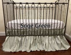 a baby crib with the name sage green on it