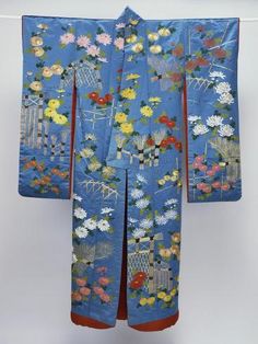 a blue kimono with flowers and birds on it