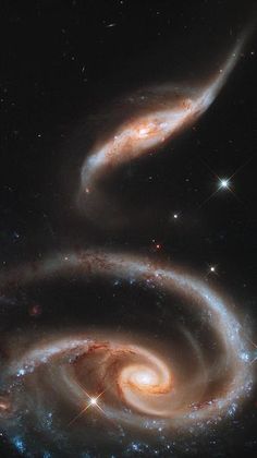 two spiral galaxy like objects in the sky