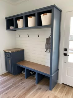 a blue bench with two baskets on it