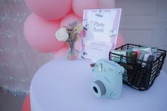 a camera and some balloons on a table