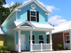 a blue house with white trim and black shutters