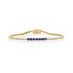 A true classic, our Diamond Four Prong Tennis Bracelet is accented with larger four prong set blue sapphires at the center. Handcrafted in 18-karat yellow gold and set with 1.50 carats of round, brilliant-cut white diamonds this bracelet has timeless appeal - the perfect gift for yourself or someone you love, because diamonds are always a good idea! Bracelet measures 6.5 inches in length Diamond Carat Weight: 1.50 ct Blue Sapphire Carat Weight: 0.53 ct Stone size: 1.5 mm / Accent - 2.5 mm Diamon Sapphire Tennis Bracelet Fine Jewelry With Prong Setting, Classic Sapphire Bracelet With Prong Setting, Classic Sapphire Tennis Bracelet With Prong Setting, Classic Sapphire Tennis Bracelet With Round Shape, Classic Round Sapphire Diamond Bracelet, Classic Sapphire-colored Cubic Zirconia Bracelets, Classic Diamond Bracelet With Sapphire, Sapphire Tennis Bracelet With Prong Setting, Classic Sapphire Bracelets With Diamond Accents