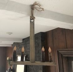 a chandelier with candles hanging from it's sides in a kitchen area