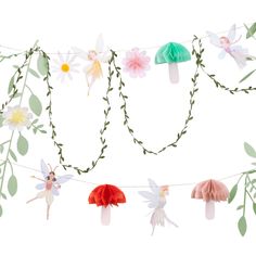 paper flowers and fairy wings are hanging on a string