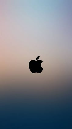 an apple logo is shown in front of a blurry blue and pink sky background