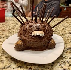 a cake shaped like an animal with chocolate icing on it's face and teeth