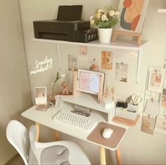 a desk with a computer, keyboard and mouse on it in front of a printer