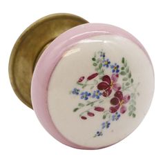 a close up of a knob on a door handle with flowers painted on the front