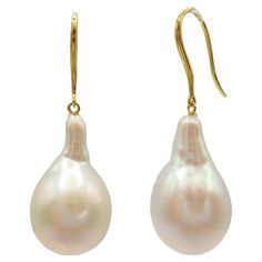 Indulge in the captivating allure of our Teardrop White Baroque Pearl Drop Earrings, meticulously crafted to inspire and captivate. These exquisite earrings showcase stunning Freshwater Cultured Baroque Pearls, boasting a brilliant white hue with a luminous luster that radiates timeless elegance. With individual weights of 15.93 carats and 15.22 carats, these teardrop-shaped pearls showcase their natural allure through their distinct shapes and mesmerizing shine. Suspended delicately from 18K Yellow Gold French Hooks, each earring emanates refinement and elegance, creating a captivating visual harmony between the soft blush of the gold and the luminous sheen of the pearls. With a total weight of 6.83 grams and a length of approximately 1.4 inches, these earrings offer a graceful and sophis Earring Video, Gold Baroque, Baroque Pearl Earrings, Pearl Diamond, Modern Earrings, Pearl Drop Earrings, Pearl Drop, Baroque Pearls, Fresh Water