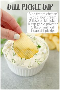 a hand dipping a chip into a bowl of dip with chips in the background and text overlay that reads, dill pickle dip