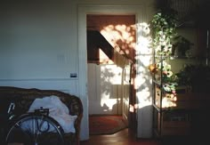 a bike is parked in front of the door to a room with plants on it