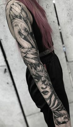 a woman with long pink hair and tattoos on her arm is standing in front of a wall