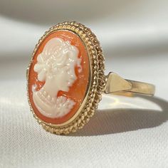 Featuring the art of handcrafted cameos designed & handmade in Italy, following a centuries-old tradition! Featuring the traditional Italian cameo carved by hand from sea shell, with an adjustable band 18kt gold plated silver sterling 925. Available also with a silver band! visit our shop for more matching pieces! Matching necklace available in our shop! Cameo size: 1.5cm X 1cm Ring size: adjustable to fit all adult sizes. Shipping: We offer free Worldwide shipping with Tracking Number. Handmade Vintage Adjustable Cameo Rings, Gold Oval Cameo Rings, Rose Gold Cameo Jewelry For Gifts, Rose Gold Cameo Jewelry Gift, Fine Jewelry Cameo Round Jewelry, Yellow Gold Cameo Rings For Gifts, Cameo Rings As Gift In Fine Jewelry Style, Vintage Cabochon Rings For Gifts, Gold Cameo Ring Jewelry