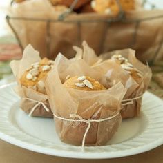 some food is sitting on a plate near other plates and bowls with bread in them