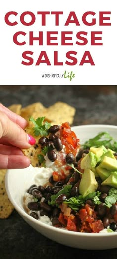 a white bowl filled with black beans and guacamole next to tortilla chips