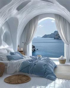 a bedroom with an ocean view is shown in this image, it has white walls and flooring